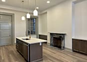 Thumbnail 8 of 15 - a kitchen with a marble counter top in front of a fireplace