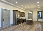 Thumbnail 2 of 15 - an open kitchen with stainless steel appliances and wood flooring