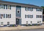 Thumbnail 1 of 5 - a white house with blue and white siding on a street