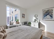 Thumbnail 7 of 67 - A bedroom with a large bed and a painting on the wall.