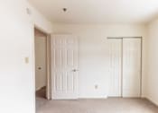Thumbnail 19 of 20 - A room with two doors and a window.