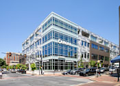 Thumbnail 53 of 67 - a large blue building on the corner of a city street
