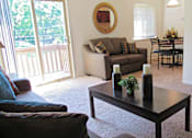 Thumbnail 5 of 10 - A living room with a couch, chairs, and a coffee table.
