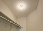 Thumbnail 35 of 48 - A white wall with a grey carpet and a white ceiling with a light on.