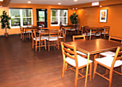 Thumbnail 18 of 19 - A restaurant with wooden tables and chairs.