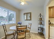 Thumbnail 10 of 16 - Mechanicsburg Apartments | Delbrook Manor Apartments | a dining room with a large window and a ceiling fan