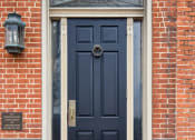 Thumbnail 22 of 26 - a blue door on a brick building