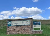 Thumbnail 2 of 19 - A sign for Evergreen Heights with a phone number and a symbol for wheelchair accessibility.