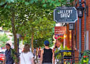 Thumbnail 52 of 67 - people walking down a sidewalk on a city street