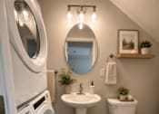 Thumbnail 45 of 48 - A small bathroom with a washer and dryer built in.