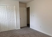 Thumbnail 3 of 7 - A room with a carpeted floor and white walls.