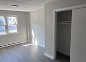 Thumbnail 19 of 23 - Empty room with a window and a door.