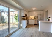 Thumbnail 31 of 48 - A modern kitchen with white cabinets and a wooden floor.