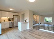 Thumbnail 36 of 48 - A kitchen with white cabinets and a refrigerator.