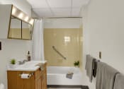 Thumbnail 16 of 18 - a bathroom with a bathtub and a sink