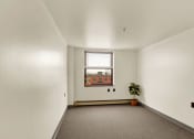 Thumbnail 18 of 18 - a bedroom with white walls and a large window