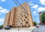 Thumbnail 2 of 18 - a large brick building with many windows
