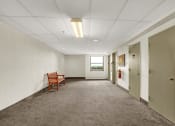 Thumbnail 8 of 18 - a long corridor with white walls and gray carpet