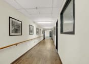 Thumbnail 13 of 18 - a long corridor with framed photographs on the walls