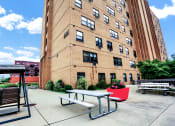 Thumbnail 3 of 18 - a picnic table sits in front of a brick building