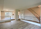 Thumbnail 33 of 48 - A spacious room with a staircase and a balcony.