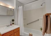 Thumbnail 14 of 15 - a bathroom with a sink and a bathtub