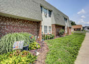 Thumbnail 1 of 15 - a bench in front of a brick house