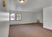 Thumbnail 11 of 15 - an empty living room with a potted plant in the corner