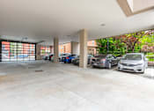 Thumbnail 23 of 73 - A parking garage with cars parked in it.
