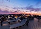 Thumbnail 23 of 67 - Apartments in Lancaster | a view of the city skyline from a rooftop terrace at sunset
