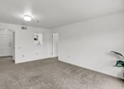 Thumbnail 12 of 16 - a bedroom with white walls and carpet