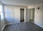 Thumbnail 8 of 23 - A room with grey flooring and white walls.
