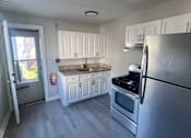 Thumbnail 7 of 23 - A kitchen with a stainless steel refrigerator, oven, and microwave.
