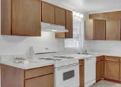 Thumbnail 19 of 26 - a kitchen with wooden cabinets and white appliances