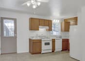 Thumbnail 18 of 26 - a kitchen with wooden cabinets and white appliances