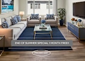 Thumbnail 1 of 41 - A living room with a couch, a coffee table, and a flat screen TV.