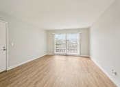 Thumbnail 41 of 64 - A room with wooden flooring and a white door.