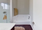 Thumbnail 3 of 18 - a white bathroom with a tub and a shower