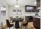 Thumbnail 5 of 41 - A modern dining room with a round table and chairs.