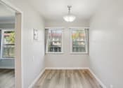 Thumbnail 16 of 51 - A room with a window and a wooden floor.