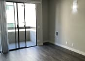 Thumbnail 15 of 54 - an empty living room with sliding glass doors and a balcony