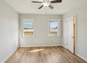 Thumbnail 14 of 51 - A room with a ceiling fan and two windows.
