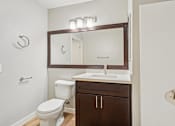 Thumbnail 65 of 66 - A white toilet sits next to a sink in a small bathroom.