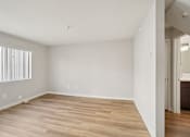Thumbnail 29 of 48 - A room with wooden flooring and white walls.