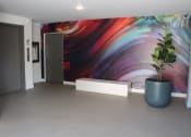 Thumbnail 15 of 18 - a large room with a plant and a painting on the wall