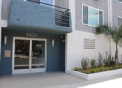 Thumbnail 14 of 18 - the entrance to a building with a glass door and a balcony