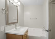 Thumbnail 9 of 64 - A white sink is on a countertop in a bathroom.
