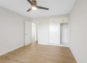 Thumbnail 63 of 64 - A room with a ceiling fan and wooden flooring.