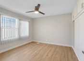 Thumbnail 54 of 64 - A room with a ceiling fan and wooden flooring.