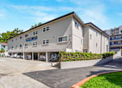 Thumbnail 45 of 49 - A building with a parking lot in front of it.